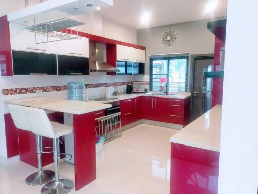 Modern kitchen with red cabinets and breakfast bar