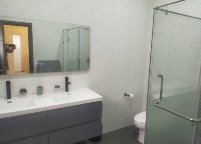 Modern bathroom with double sink and glass shower