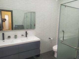 Modern bathroom with double sink and glass shower