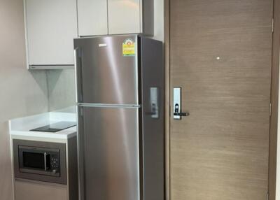 Modern kitchen with stainless steel refrigerator