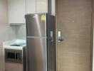 Modern kitchen with stainless steel refrigerator