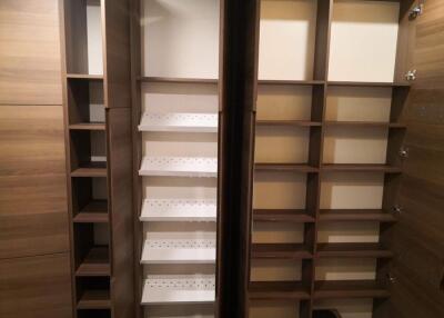 Spacious wooden closet with multiple shelves