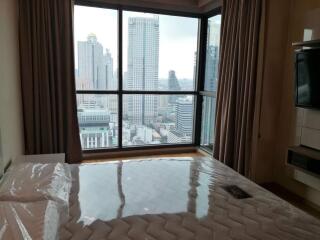 Bedroom with a view of the city skyline