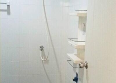 Modern bathroom shower area with white tiles