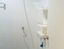 Modern bathroom shower area with white tiles