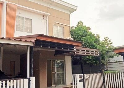 Two-story house with a covered entrance and fenced yard