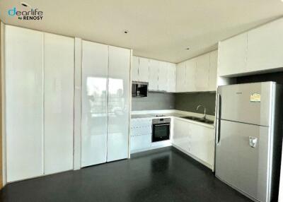 Modern kitchen with white cabinets and stainless steel appliances