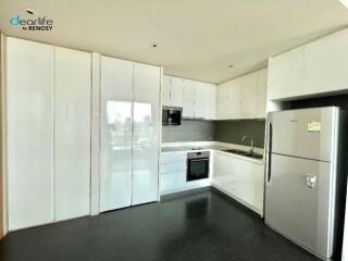 Modern kitchen with white cabinets and stainless steel appliances