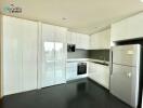 Modern kitchen with white cabinets and stainless steel appliances