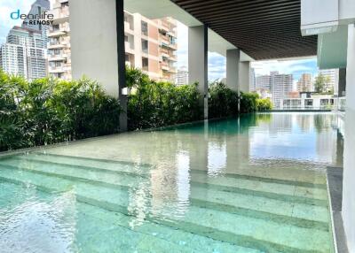 Outdoor swimming pool with cityscape view