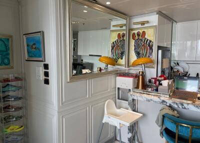 Modern kitchen area with breakfast bar and vibrant artwork