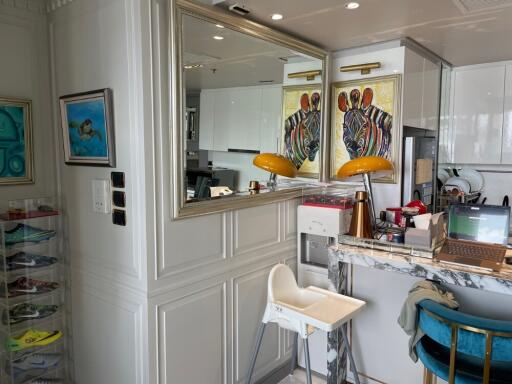 Modern kitchen area with breakfast bar and vibrant artwork