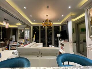 Modern living room with chandelier and ample lighting