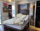 Bedroom with a double bed, wall decor, bookshelf, and a baby safety rail