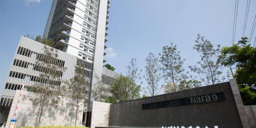 Exterior view of a tall modern residential building named Nara 9 with landscaped surroundings