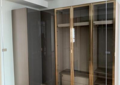 Empty bedroom with wooden flooring and fitted wardrobe