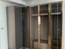 Empty bedroom with wooden flooring and fitted wardrobe