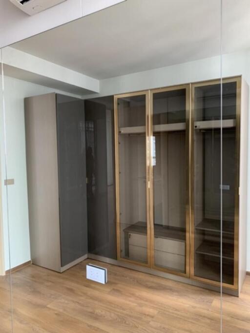 Empty bedroom with wooden flooring and fitted wardrobe