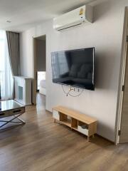 Modern living room with wall-mounted TV and air conditioning