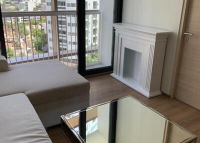 Modern living room with city view, featuring a fireplace and mirrored coffee table