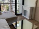 Modern living room with city view, featuring a fireplace and mirrored coffee table