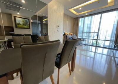 Modern dining area with mirror wall and large windows