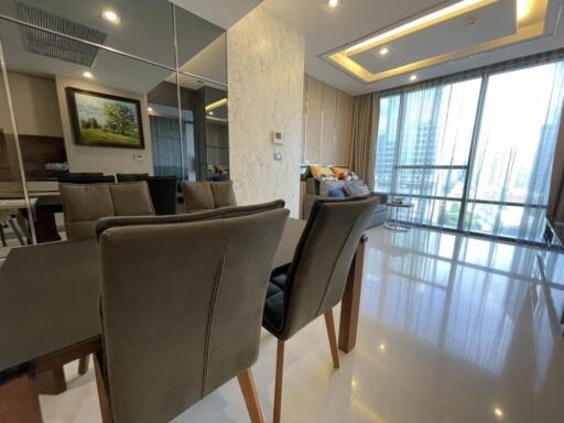 Modern dining area with mirror wall and large windows