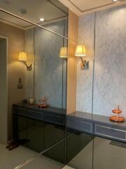 Entrance area with mirrored wall and marble accents