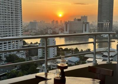 Balcony view at sunset with river and cityscape