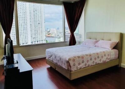 Bedroom with a large bed, TV and city view