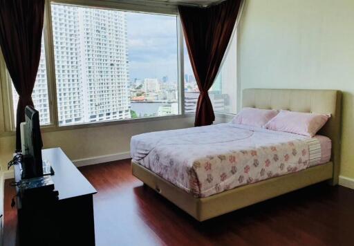 Bedroom with a large bed, TV and city view