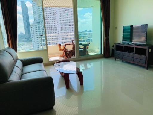 Living room with a large window and balcony view