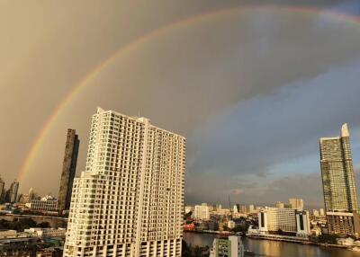 City skyline with a rainbow and high-rise buildings