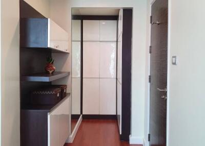 Modern hallway with wooden flooring and stylish cabinetry