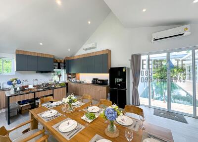 Modern kitchen and dining area with pool view