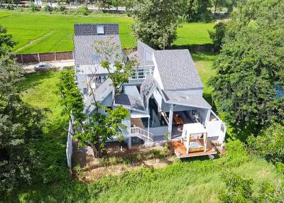 Aerial view of a modern house surrounded by greenery