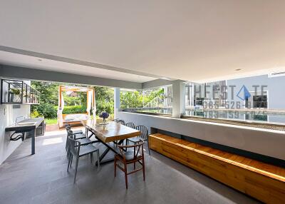 Spacious outdoor patio with dining area and greenery