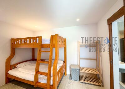 Bedroom with bunk bed and storage shelves