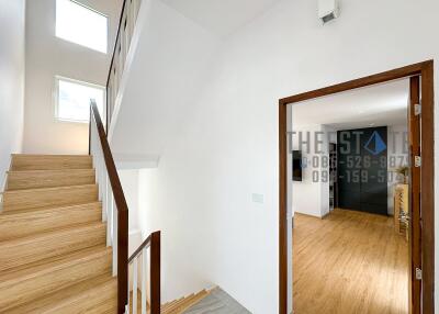 Stairway and hallway with a view into a room