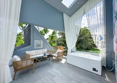 Modern living area with outdoor view and hot tub