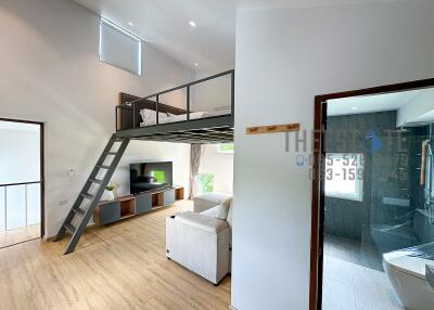 Modern living room with lofted bedroom area