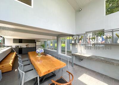 Modern dining space with large wooden table and chairs