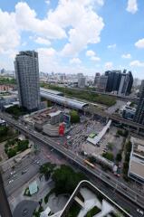 Aerial view of the city with tall buildings, roads, and construction sites