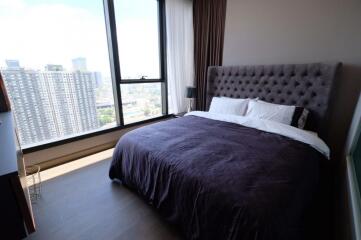 Modern bedroom with large window and city view