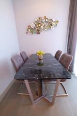 Modern dining room with a dark marble table and stylish chairs