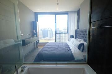 Modern bedroom with large window and city view