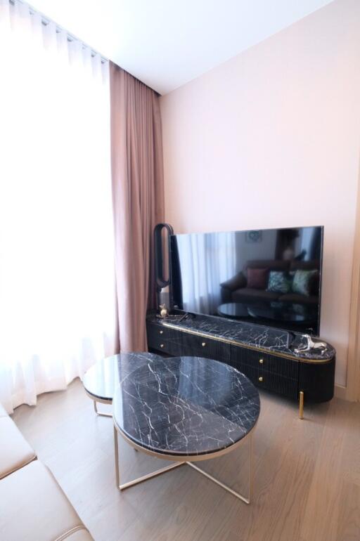 Modern living room with a marble coffee table and large TV