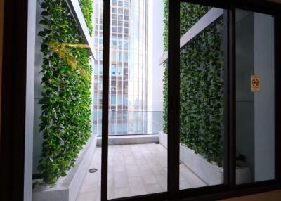 Balcony with green foliage and city view