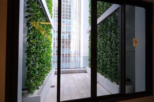 Balcony with green foliage and city view