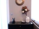 Elegant corner with a small black cabinet and decorative items